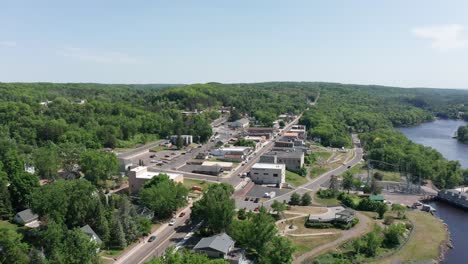 Wide-push-in-aerial-shot-of-small-town-Saint-Croix-Falls,-Wisconsin