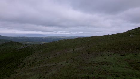 Aerial-drone-footage-of-lush-mountain-range-on-an-overcast-day