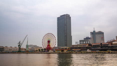 Moving-timelapse-at-Kobe-city-Hyogo-Osaka-cloudy-day-at-Harborland-panning-ferris-wheel