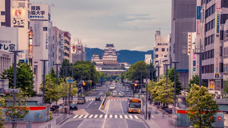 Himeji-Castle-time-lapse-at-train-shinkansen-station-cloudy-sunset-traffic-lights-and-buses