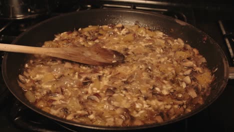 Italian-Mushroom-Risotto-Cooking-and-Steaming-in-Frying-Pan-with-Wooden-Spoon