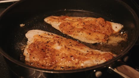 Sea-Bass-Fillets-Cooking-in-Thai-Style-Butter-in-Hot-Frying-Pan
