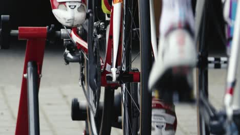A-close-up-of-the-legs-of-cyclists-pedalling-on-the-pedals-of-racing-specials-placed-against-each-other-on-rollers