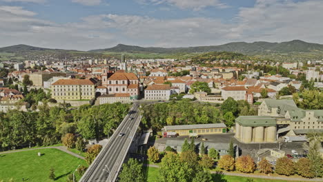 Litomerice-Czechia-Aerial-v1-flyover-Elbe-river-along-the-bridge-towards-town-center-capturing-charming-townscape,-All-Saints-church-and-hillside-landscape---Shot-with-Mavic-3-Cine---November-2022