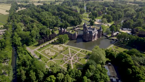 Park-view-from-above-aerial-showing-historic-picturesque-castle-Ter-Haar-in-Utrecht-with-typical-towers-and-fairy-tale-cants-facade-exterior-on-a-bright-day-with-landscaping-gardens-in-the-foreground