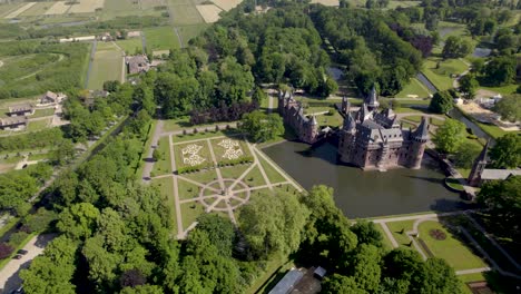 Aerial-showing-historic-picturesque-castle-Ter-Haar-in-surrounding-Utrecht-landscape-with-typical-towers-and-fairy-tale-cants-facade-exterior-on-a-bright-day-with-landscaping-gardens-in-the-foreground