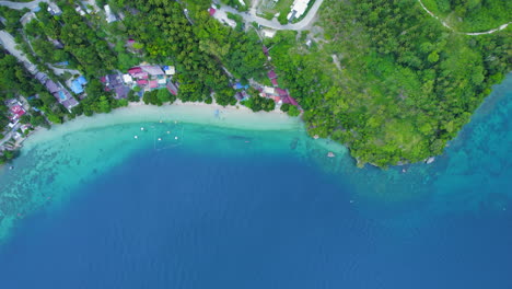 Top-Down-Aerial-Drone-View-Of-Turquoise-Blue-Island-Beach-With-Lush-Green-Tropical-Foliage-In-The-Philippines
