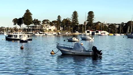 Moored-Motor-Boat-close-up,-yachts-and-Royal-Freshwater-Bay-Yacht-Club-on-Swan-River-at-Peppermint-Grove,-Perth,-Western-Australia