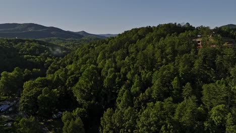 Helen-Georgia-Aerial-v11-cinematic-drone-flyover-alpine-village-town,-pedestal-up-capturing-beautiful-mountainscape-covered-in-lush-green-forests-at-daytime---Shot-with-Mavic-3-Cine---October-2022