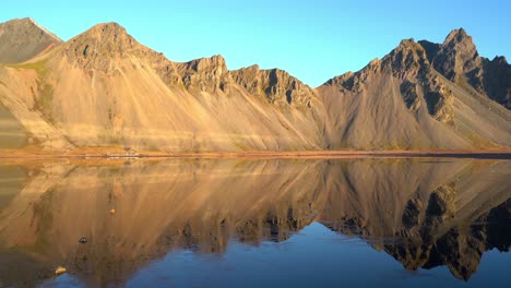 Reflection-of-Vestrahorn-mountain-on-Stokksnes-beach-on-sunny-day---South-Iceland