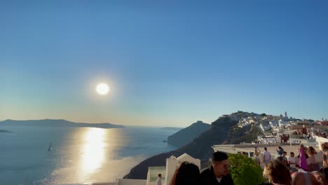 Nice-view-of-the-bright-sun-shining-on-the-Cretan-Sea-in-Oia,-Santorini