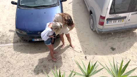 aerial-view-of-two-friends-are-looking-at-the-photos-on-the-camera-after-they-have-been-taken