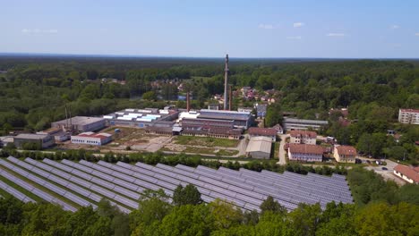 Dramatic-aerial-top-view-flight-Solar-field-plant-factory-at-village-Chlum,-Czech-Republic-Summer-2023