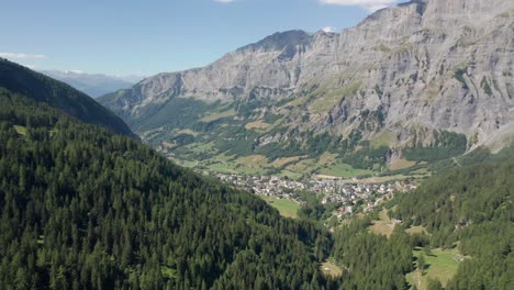 Drone-slowly-flying-towards-a-quiet-mountain-town-in-Switzerland
