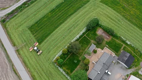 Tractor-In-Field-Mows-Grass---aerial-top-down