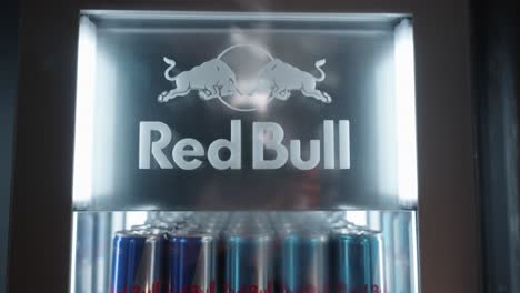 Close-up-of-Red-Bull-logo-on-a-display-fridge-with-cans-inside