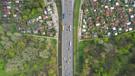 Top-down-aerial-of-busy-highway-intersection,-tilt-up-reveals-bridge,-Vienna