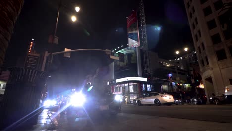 ground-level-street-view-of-a-busy-downtown-LA-street-at-night