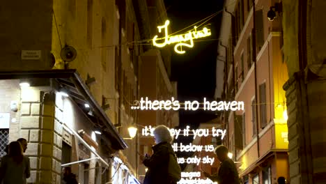 Illuminated-Lyrics-To-Imagine-By-John-Lennon-Hanging-Along-Via-d'Azeglio-In-Bologna-Near-Piazza-Maggiore-At-Night