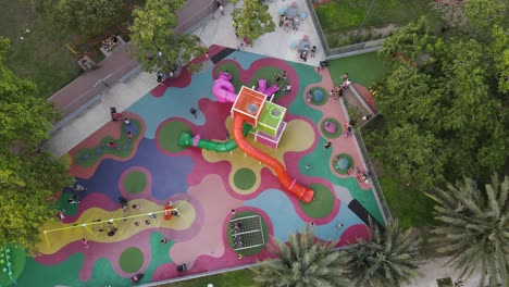 Kids-playing-at-children's-playground-in-Buenos-Aires-City,-aerial-closeup