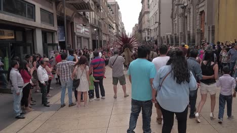 Crowd-of-people-looking-some-aztec-performers-dancing-in-the-streets-of-Mexico-City