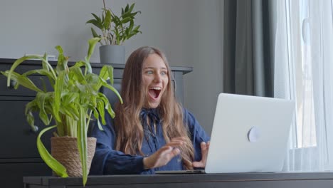 Reaction-of-happy-woman-at-office-while-reading-exciting-news-at-laptop