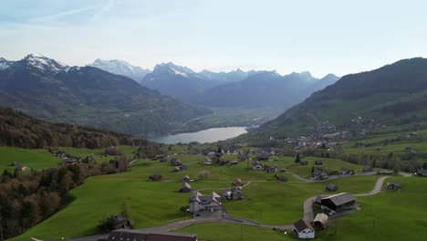 Aerial-view-of-picturesque-alp-village-with-mirror-like-lake
