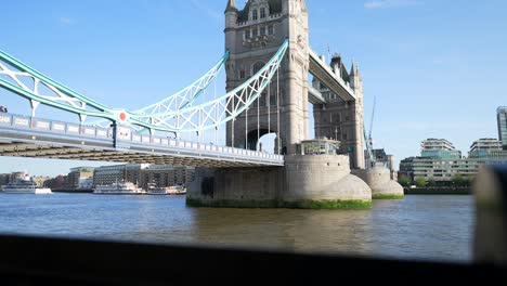 tilt-up-slow-motion-shot-of-Tower-Bridge-and-river-Thames,-London-tourist-Tower-of-London,-The-Shard,-City-skyline,-cinematic-movement-in-bright-sunny-weather,-spring-summer-day,-seasonal-character