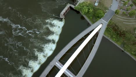 Iowa-Women-of-Achievement-Bridge-over-Des-Moines-River-in-Des-Moines,-Iowa-with-drone-video-overhead-and-spinning