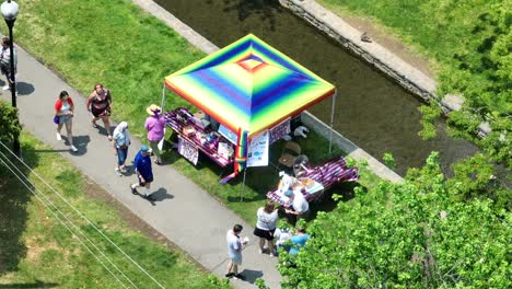Aerial-top-down-shot-of-people-walking-on-path-at-LGBTQ-Pride-Parade-Festival-in-Lititz-during-sunny-day