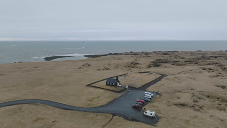 Drone-Shot-of-Búðir-Kirkja,-Religious-Landmark-of-Iceland-on-Cold-Spring-Day
