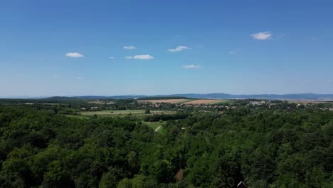 Aerial-Hyperlape-on-a-cloudy-summer-day-at-the-Hungarian-Countryside,-near-Nagyoroszi