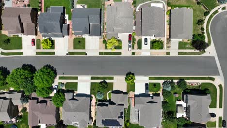 Top-down-aerial-shot-of-cookie-cutter-HOA-neighborhood-in-summer