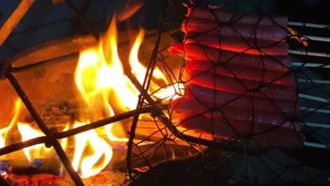 Skewered-sausages-are-grilled-on-a-hot-grill-over-traditional-fireplace