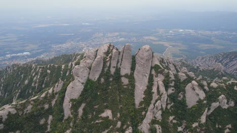 Aerial-shot-of-the-unique-mountain-formation-by-drone-close-to-the-Monestary-of-Montserrat-in-Spain,-Europe
