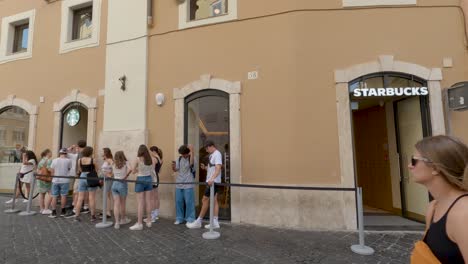 People-Waiting-in-line-at-Starbucks-on-Typical-Day-in-Rome,-Italy