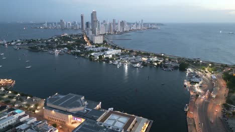 Cartagena-Colombia-aerial-cityscape-with-Caribbean-Sea-at-sunset-illuminated-with-contrast-between-old-historical-downtown-and-modern-skyscraper-building-drone-footage