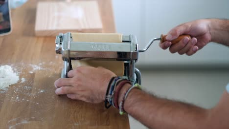 Slow-Motion-Pasta-Creation:-Man's-Expertise-with-Traditional-Pasta-Machine---Close-Up-4K-Shot