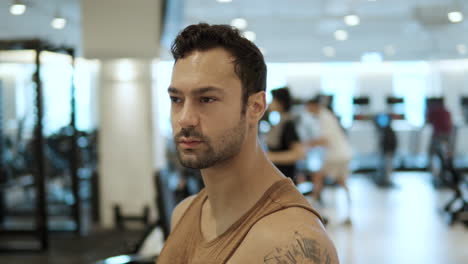 Young-French-Bodybuilder-Thinking-After-Workout-Standing-at-Gym--Face-Closeup