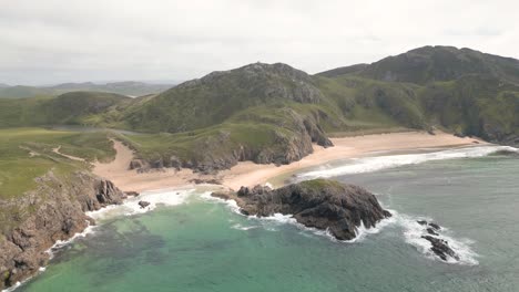 Breathtaking-aerial-view-of-Murder-Hole-Beach,-a-hidden-gem-on-the-coast-of-County-Donegal,-Ireland