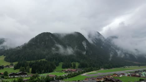 Drone-shot-of-three-hills-in-the-Swiss-alps---Gstaad,-Saanen,-Switzerland---slowly-up