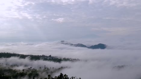 Fly-over-hills-shrouded-by-clouds-in-the-morning