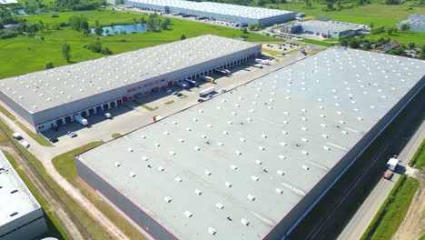 Aerial-view-of-distribution-center,-drone-photo-of-industrial-logistics-zone,new-super-modern-logistics-center-full-of-modern-technology-and-robotics,roof-solar-power-plant-for-green-energy-production