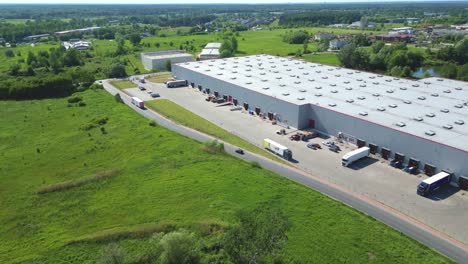 Aerial-view-of-distribution-center,-drone-photo-of-industrial-logistics-zone,new-super-modern-logistics-center-full-of-modern-technology-and-robotics,roof-solar-power-plant-for-green-energy-production