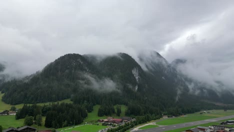 Drone-shot-of-three-hills-in-the-Swiss-alps---Gstaad,-Saanen,-Switzerland---slow-push