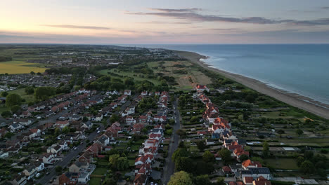 Sunset-over-Skegness,-a-popular-seaside-resort-with-stunning-campsites,-holiday-homes,-and-a-drone's-eye-view