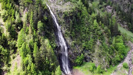 Zooming-into-the-waterfall-near-Wager-Alm-Mittersill-in-Austria,-aerial