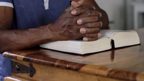 man-praying-to-God-with-hand-on-bible-with-people-stock-video-stock-footage