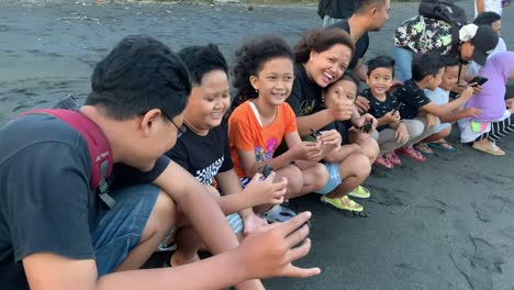 Indonesia---Jul-9,-2023-:-people-preparing-to-release-hatchlings-on-Goa-Cemara-beach-in-Bantul,-Yogyakarta