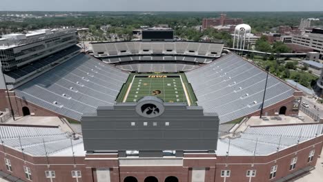 Kinnick-stadium-on-the-campus-of-the-University-of-Iowa,-home-of-the-Iowa-Hawkeyes-in-Iowa-City,-Iowa-with-drone-video-pulling-back-and-up-parallax